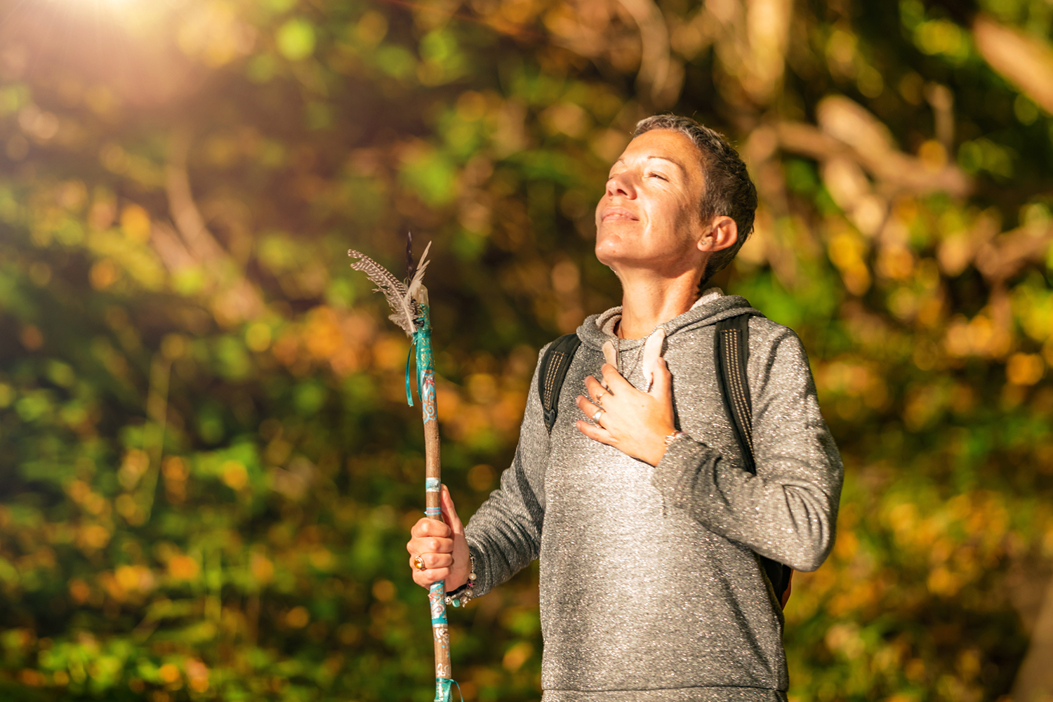 a spiritual woman enjoying a peacful moment while on an autumn hike