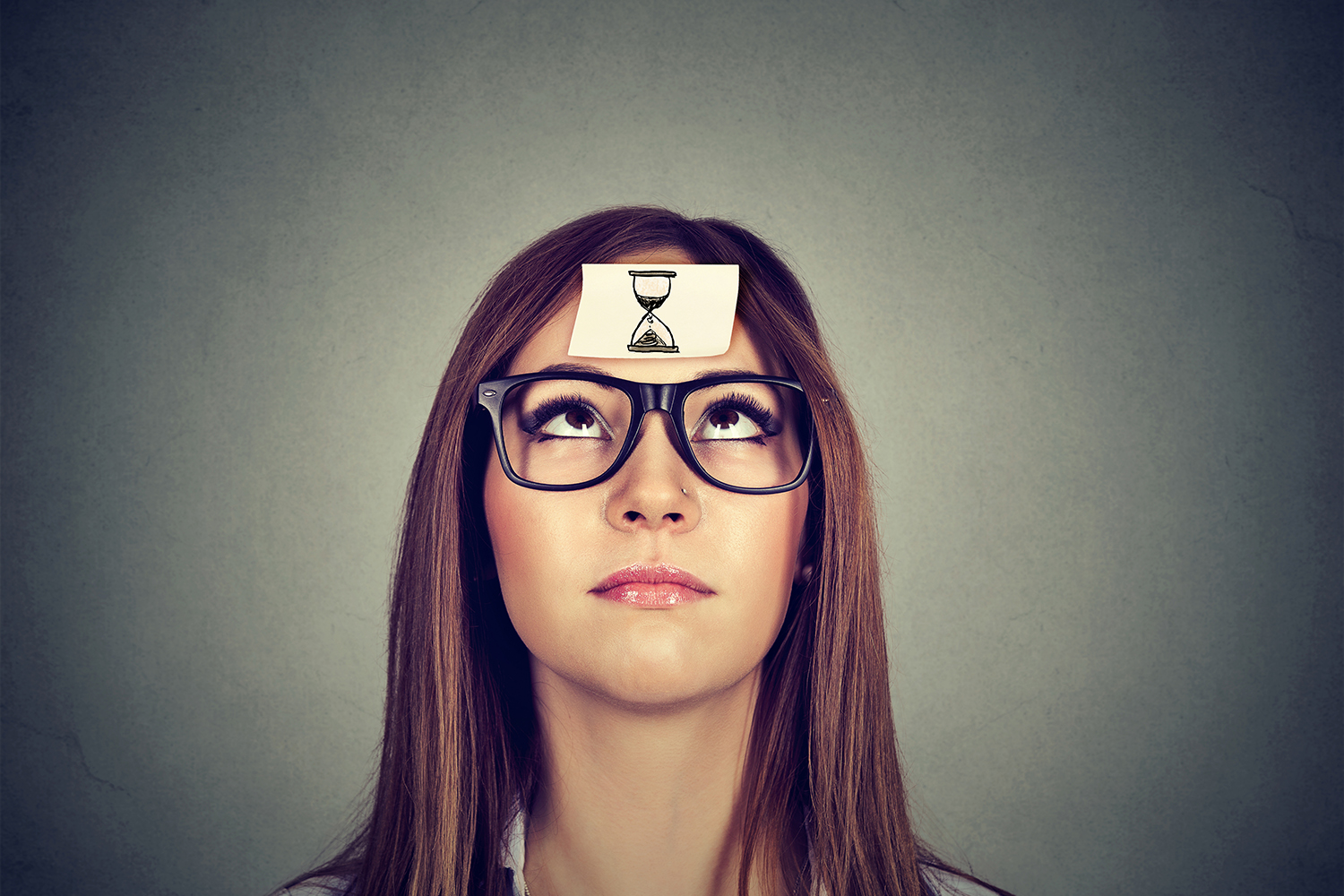 a woman with a picture of an hourglass stuck to her forehead