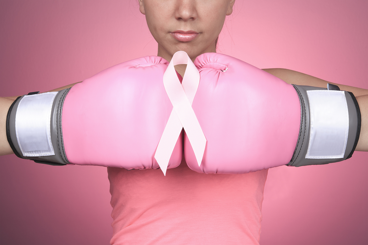 a woman with boxing gloves fighting breast cancer