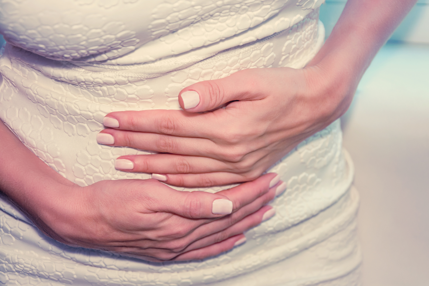 A woman rubbing her uncomfortable stomach