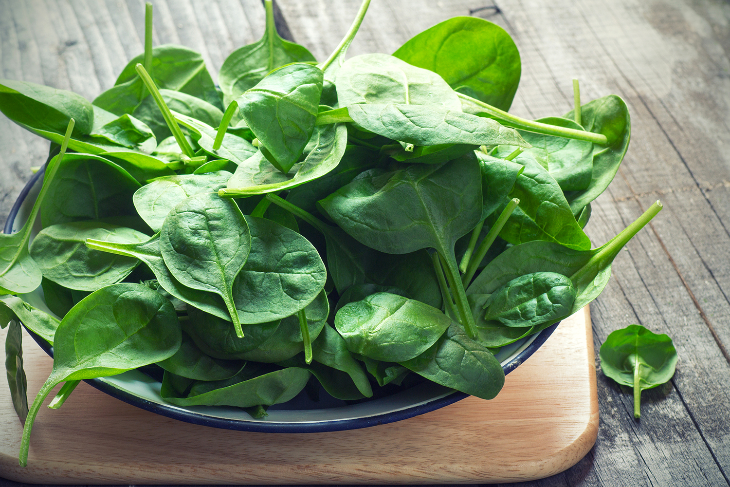 fresh baby spinach piled high in a dish