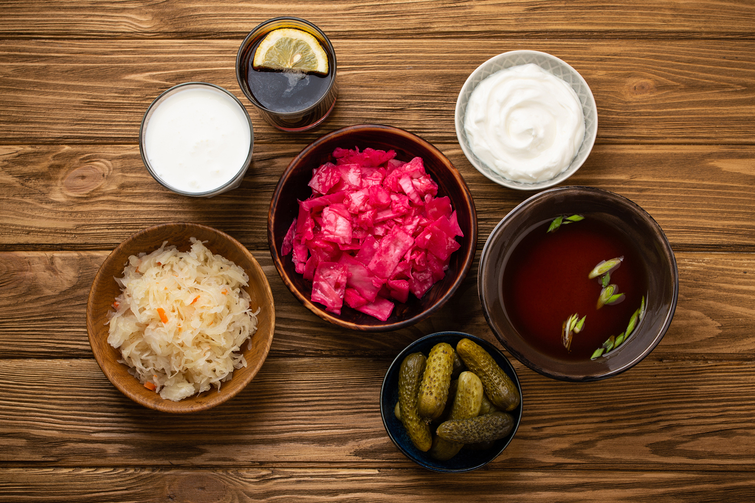 different fermented foods in jars and bowls