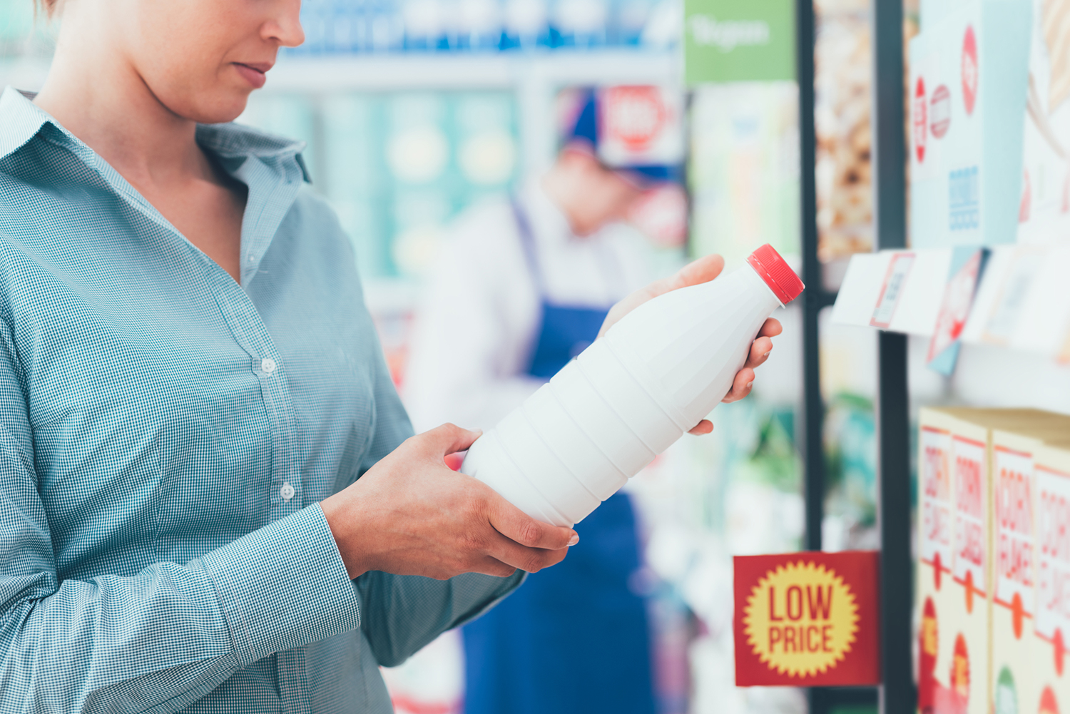 a woman reading labels in the grocery store