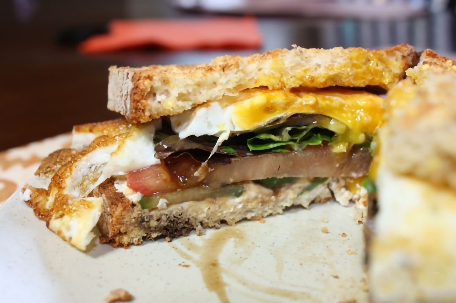 an egg sandwich with goat cheese, spinach, and cucumber