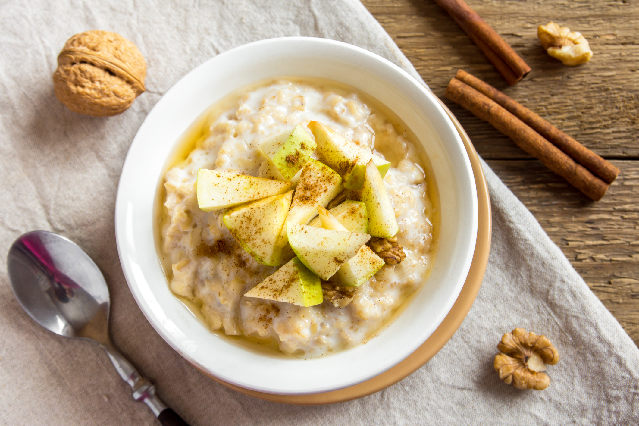 Bowl of oatmeal with cinnamon and walnuts. 
