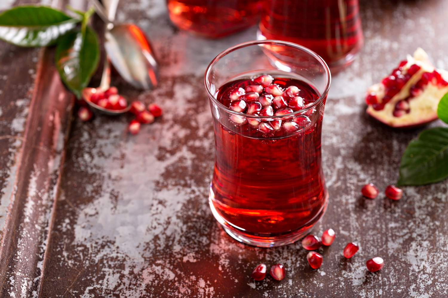 a glass of sparkling pomegranate drink on ice