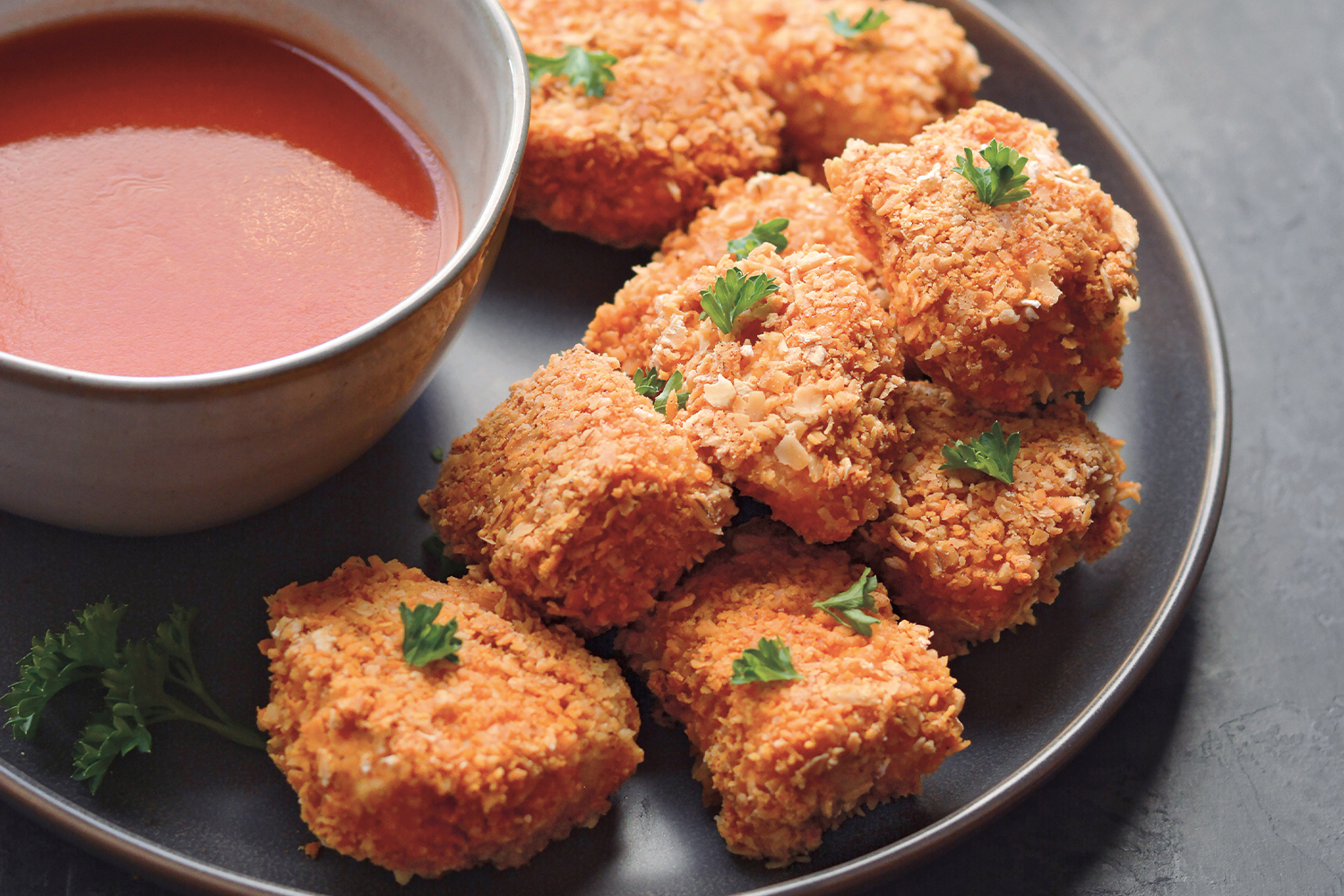 breaded chicken served with red dipping sauce