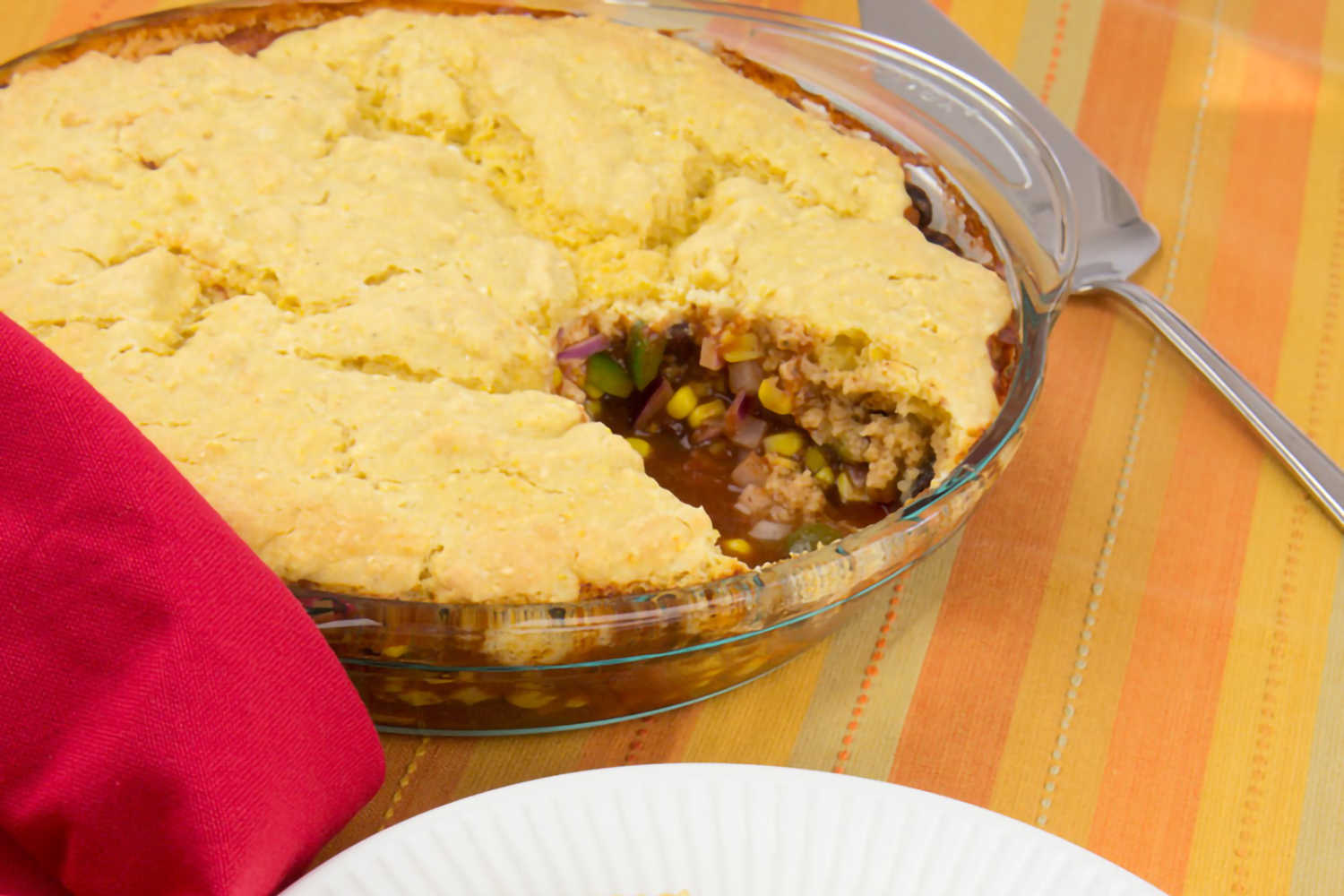 a pie dish of beans topped with a cornbread crust