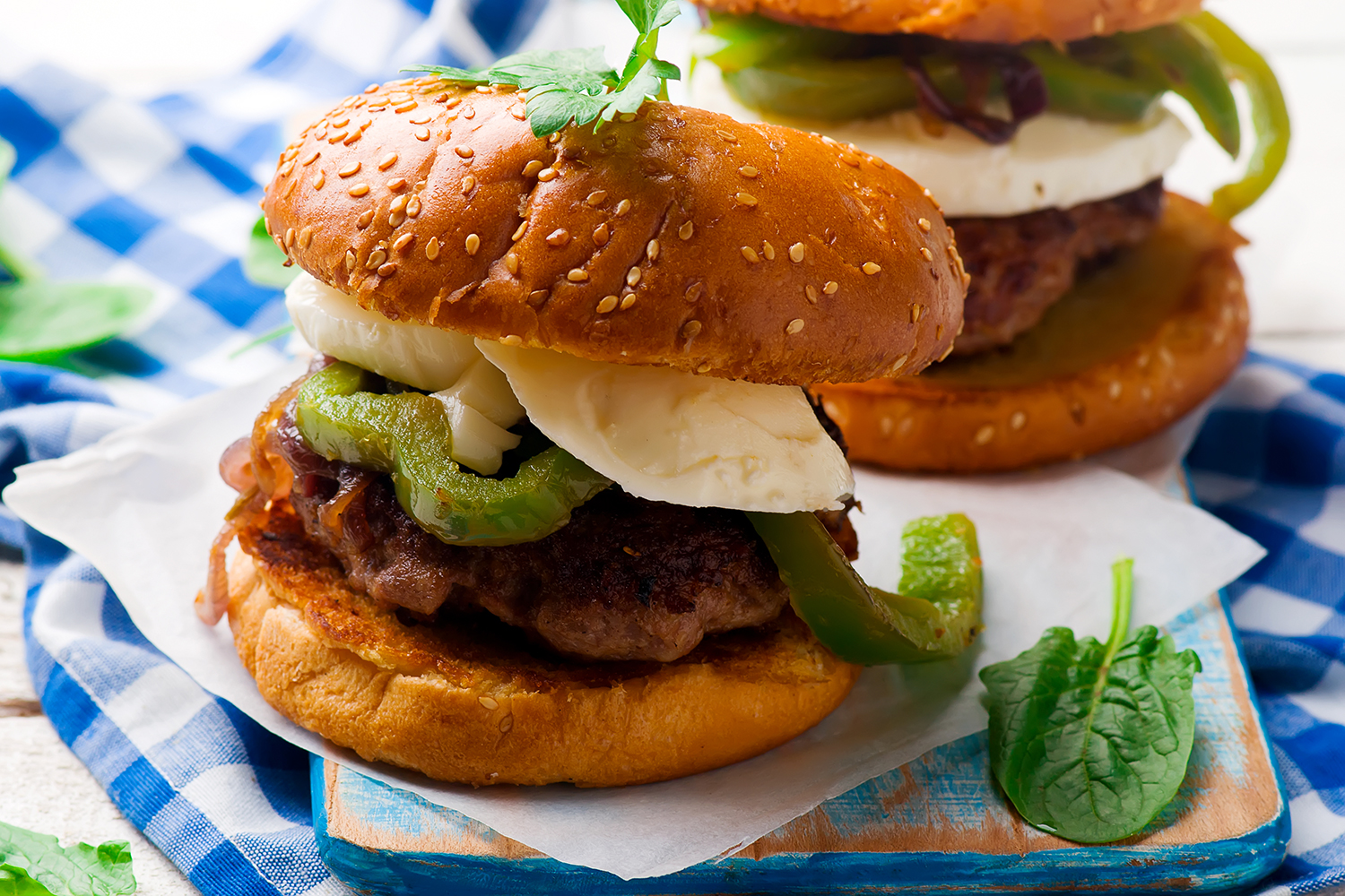 A plate of chicken sausage sliders with bell peppers and fresh basil