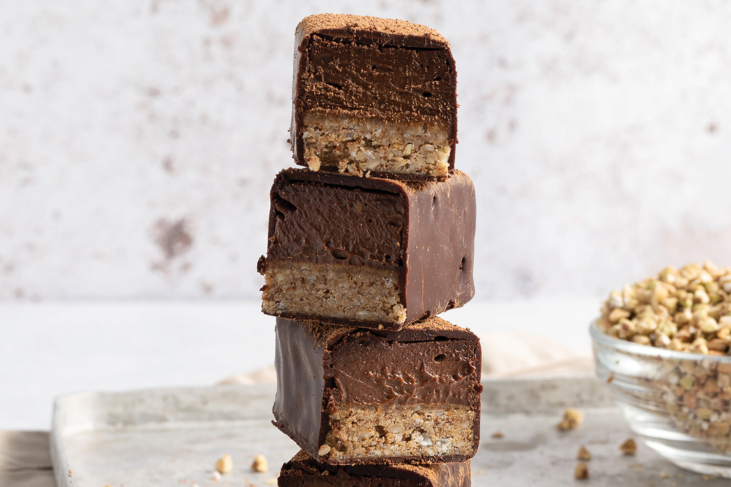a stack of crunchy mousse bars enrobed in chocolate