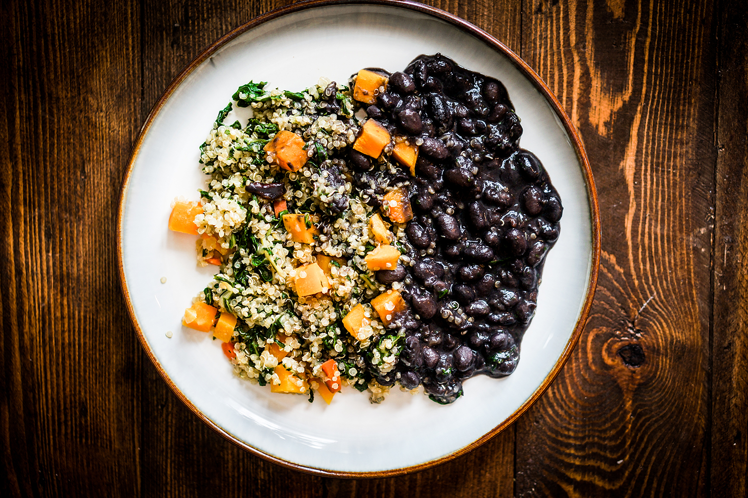A plate of black beans, quinoa, and bell peppers