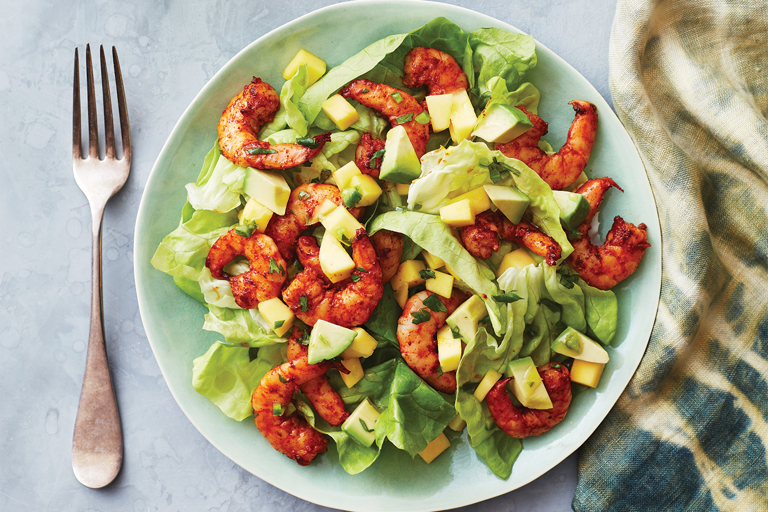 A plate of shrimp and mango salad