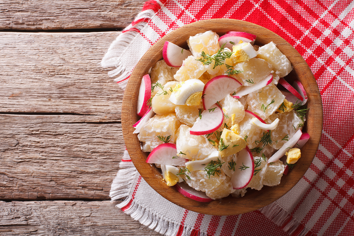 Fresh Spring Potato Salad in a wooden bowl ready to serve.