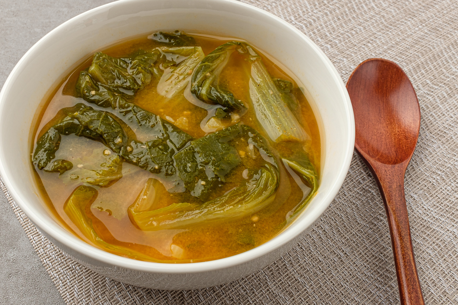 a bowl of miso soup with cabbage