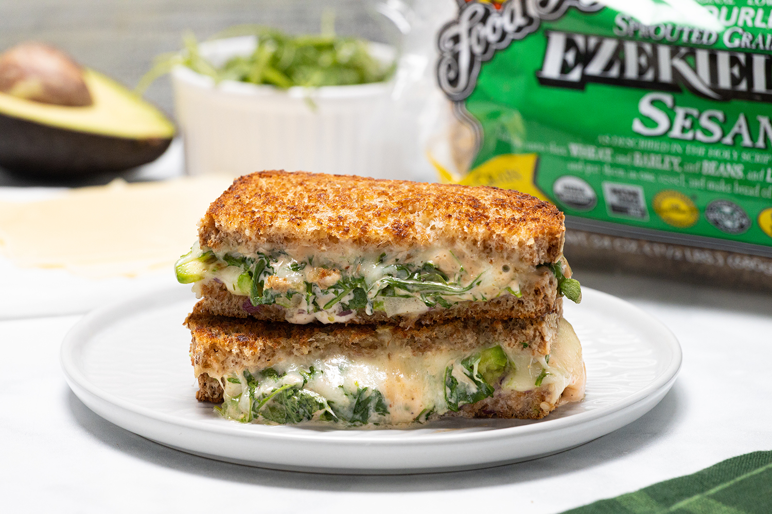 a vegan melt with arugula on golden pan-cooked toast