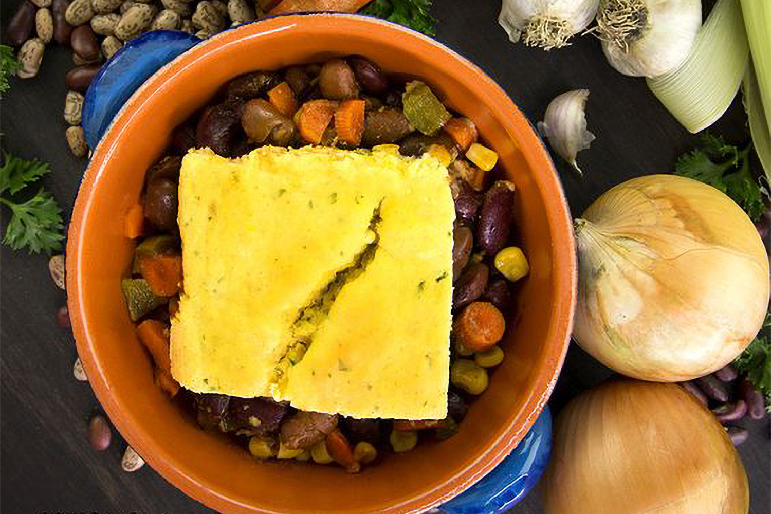 cornbread on top of a bowl of vegetarian chili