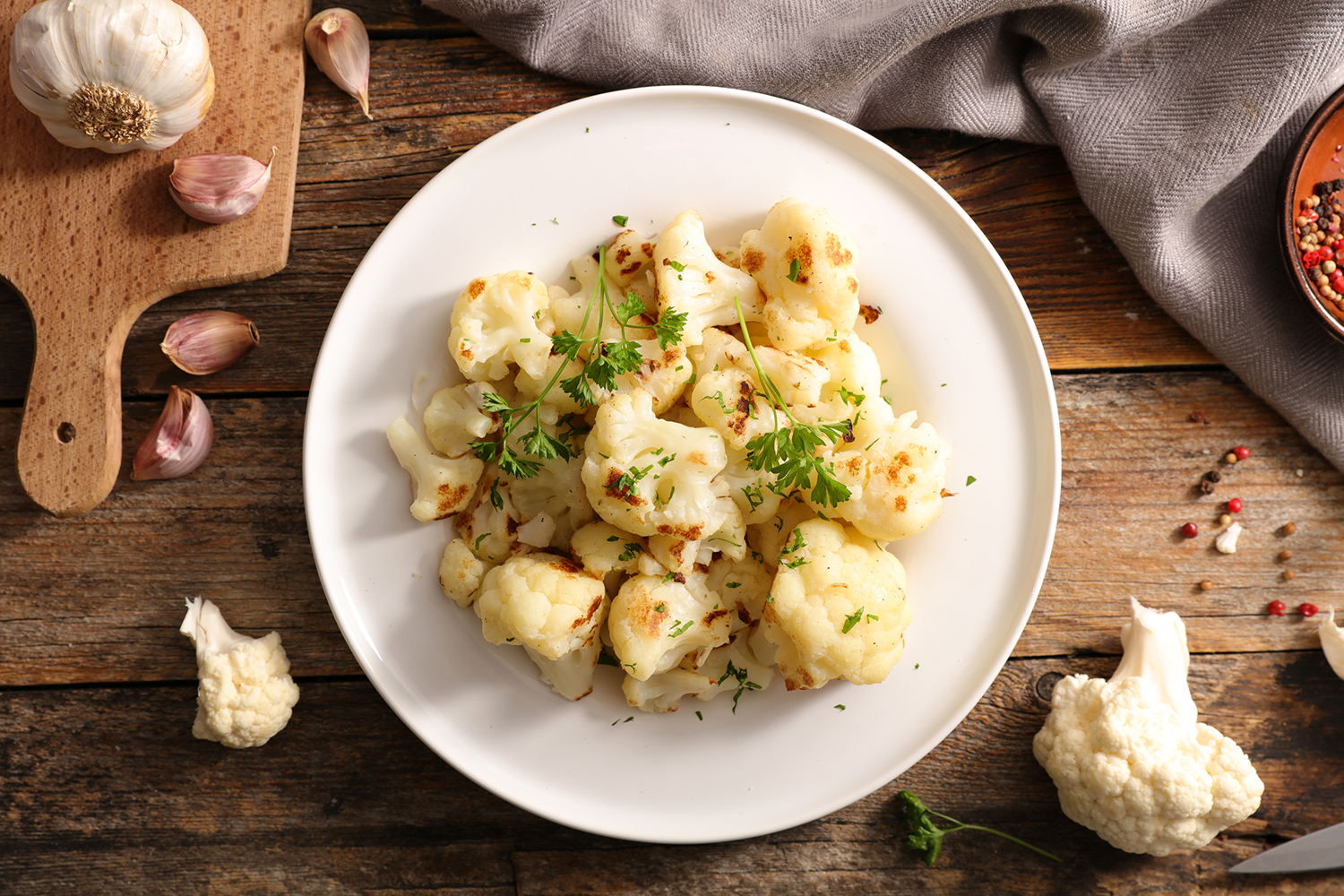 grilled cauliflower plated with a garnish
