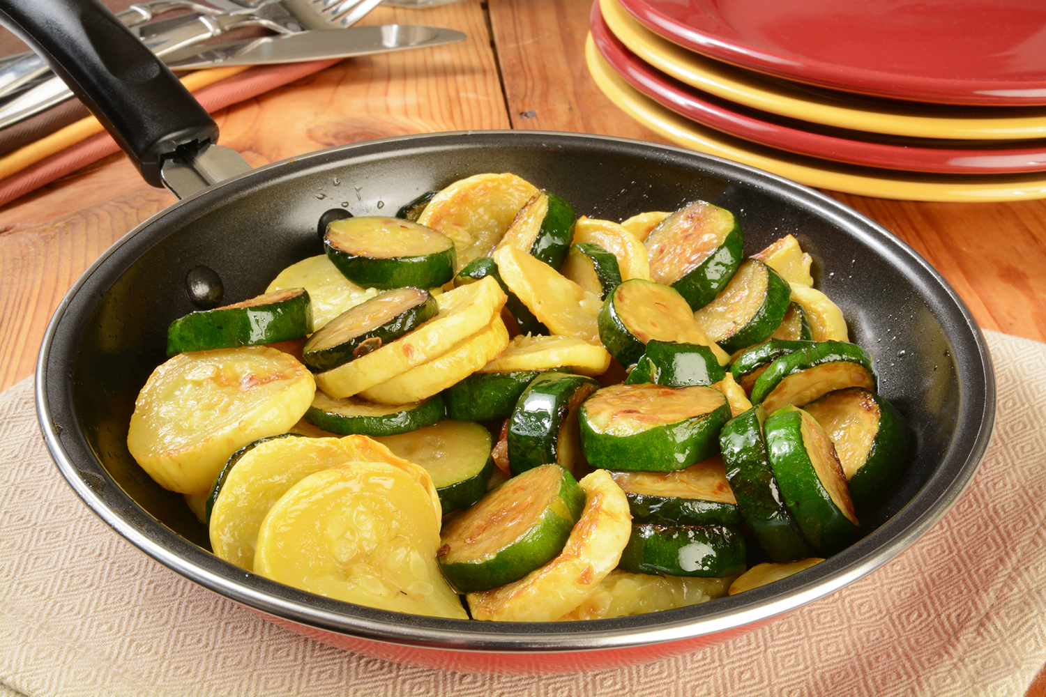yellow and zucchini squash in a frying pan