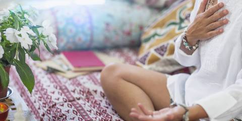 a woman wearing beads and meditating