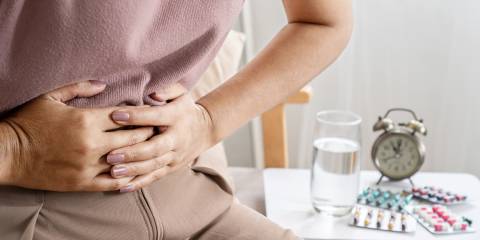 a woman clutching her abdomen in pain