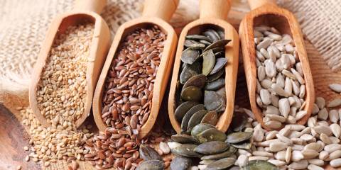 scoops of sesame, flax, pumpkin, and sunflower seeds