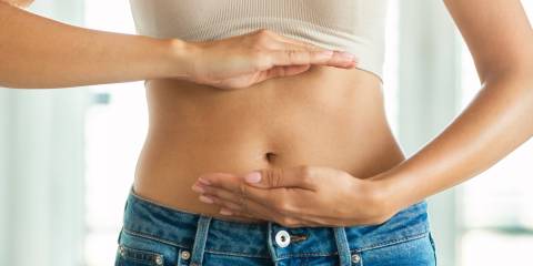 a woman showing off her flat tummy