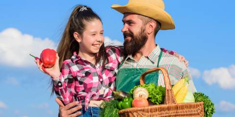 a farmer and his daughter with an organic harvest