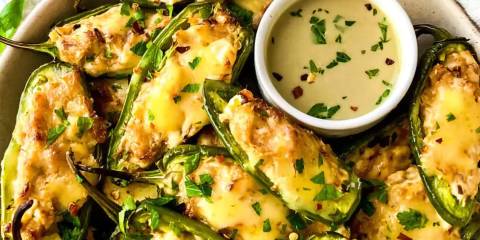 a plate of jalapeño peppers stufffed with cream cheese and fish
