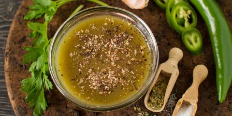 Magic Green sauce in a small glass bowl surrounded by ingredients.