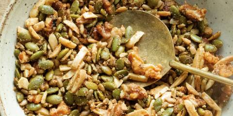a bowl of granola, nuts, and seeds