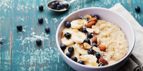 A bowl of oatmeal with blueberries and almonds. 