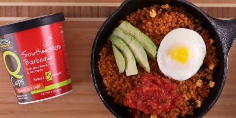 A pan of quinoa, egg, avocado, and salsa
