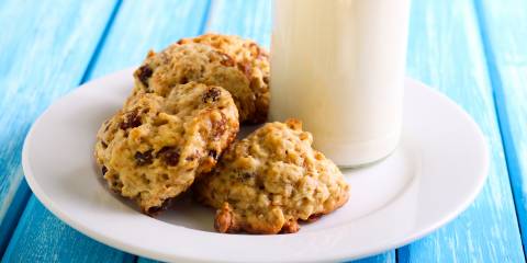 Applesauce raisin cookies on a plate with milk