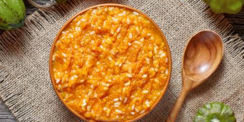 a bowl of rice pudding with squash and spices