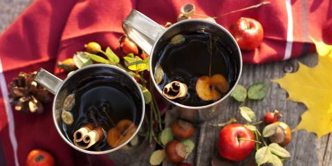 hot mugs of red tea with apple and cinnamon