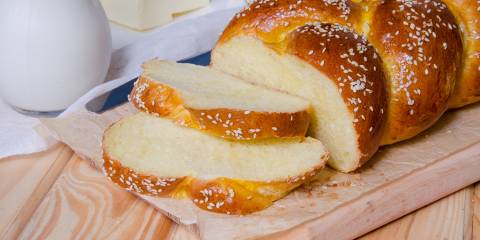 a freshly baked loaf of traditional braided challah bread