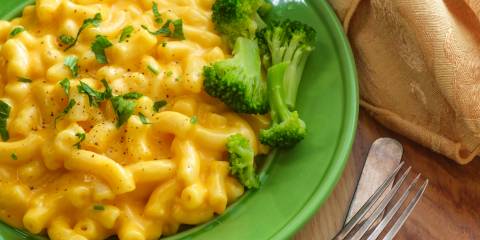 a plate of cheesy macaroni with broccoli