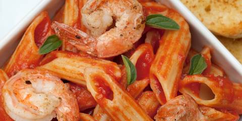 a bowl of penne and shrimp in red sauce