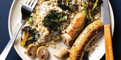 a plate of sausage, barley, and broccoli