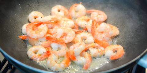 deveined shrimp frying in a hot wok