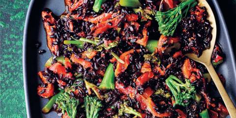 a plate of spiced black rice with vegetables