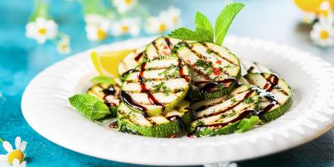a plate of grilled zucchini drizzled in balsamic