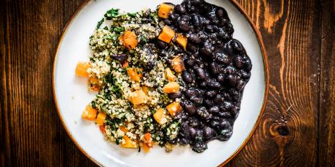 A plate of black beans, quinoa, and bell peppers