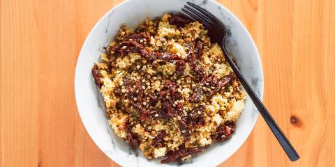 a bowl of couscous with lentils and veggies