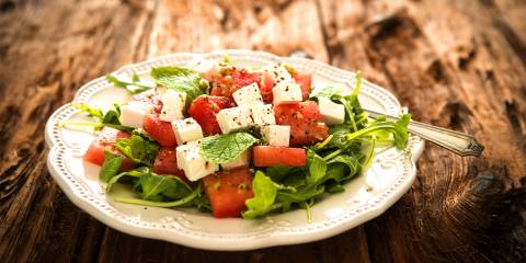 A mmix of watermelon, arugula, and feta cheese