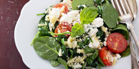 a plate of spinach with crumbled feta