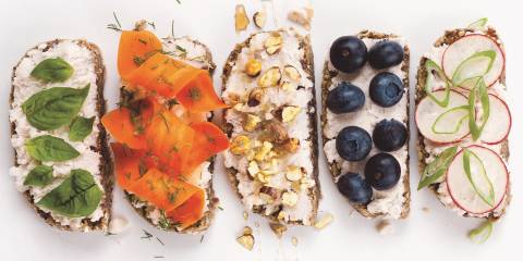 Almond Ricotta on five slices of bread with different toppings in a row.