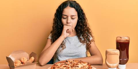 a girl having trouble breathing while eating junk food