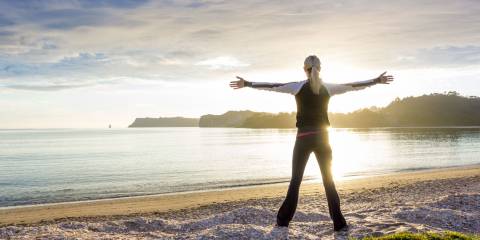 energized woman on the beach in the morning
