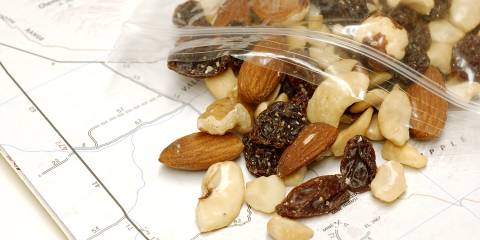 A bag of trail mix spilled out on to a trail map